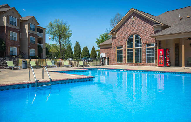 Swimming pool surrounded by club house and apartments