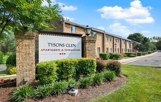 A sign for Tysons Glen Apartments and Townhomes stands in front of a row of buildings.