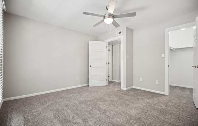 an empty living room with a ceiling fan and a closet at Shellbrook, Raleigh, North Carolina