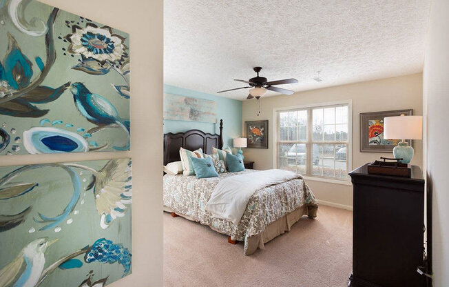 large bedroom with ceiling fan and natural light
