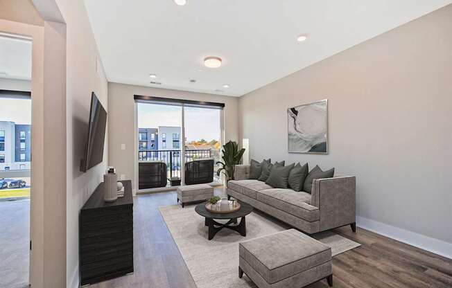 A living room with a grey couch and a coffee table.
