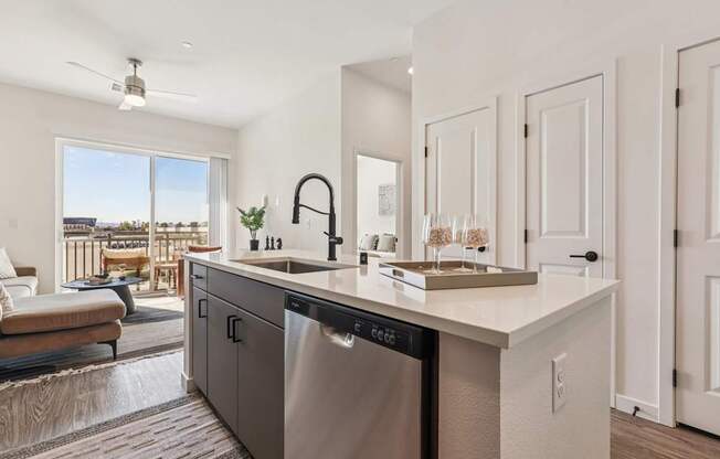 A modern kitchen with a large island and stainless steel appliances.