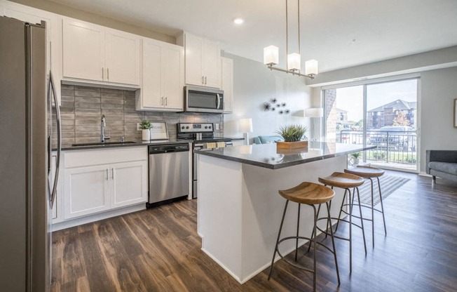 Kitchen with pendant lighting and island at Ascend at Woodbury new luxury apartments in Woodbury MN 55129