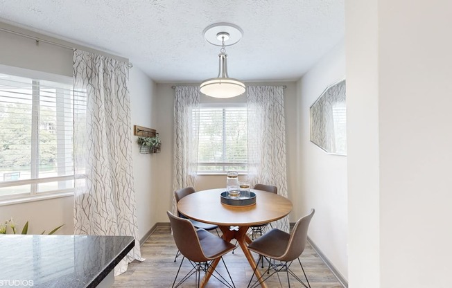 an image of a dining room with a table and chairs