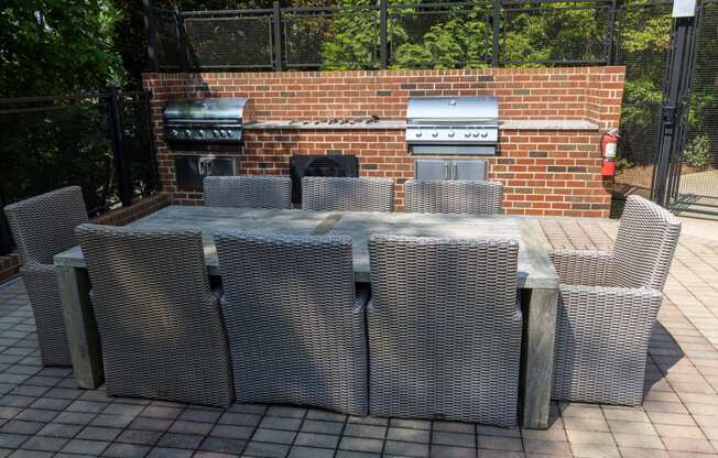 a large outdoor kitchen with a grill and a dining table
