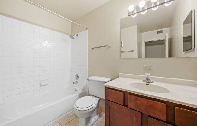 Bathroom with mirror and cabinets at Woodland Ridge Apartments in Woodridge, IL