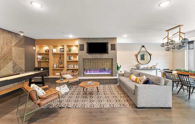 A modern living room with a fireplace and a television.