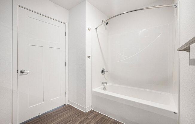 a white bathroom with a shower and a tub  at Signature Pointe Apartment Homes, Alabama