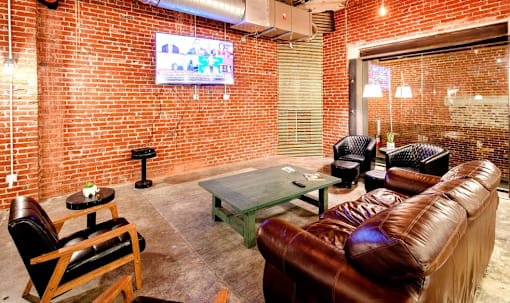 a living room with leather furniture and a tv