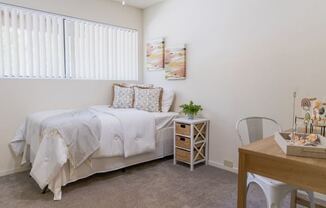 A bedroom in a model apartment at Cranbrook.