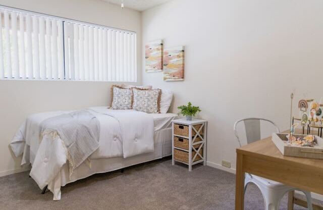 A bedroom in a model apartment at Cranbrook.