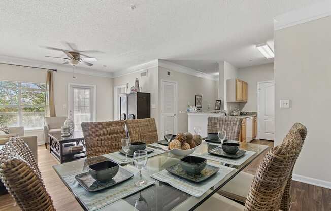 A dining room with a glass table and chairs.