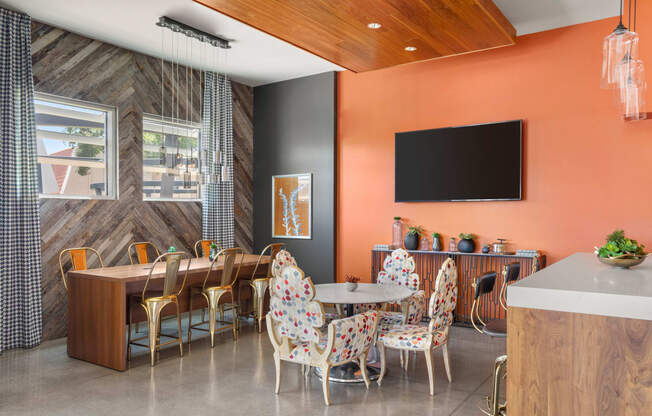 a meeting room with orange walls and a wooden ceiling