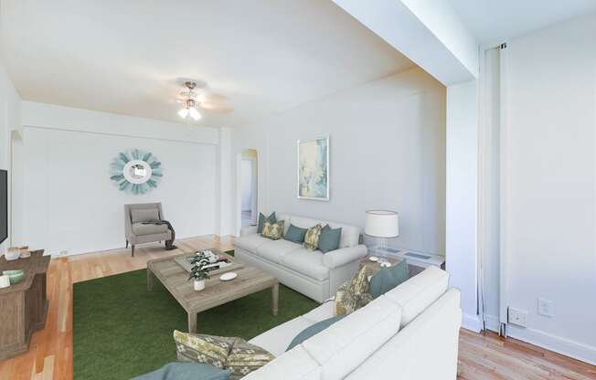 living area with sofa, coffee table, sitting area, hardwood flooring, and ceiling fan at the frontenac apartments in washington dc