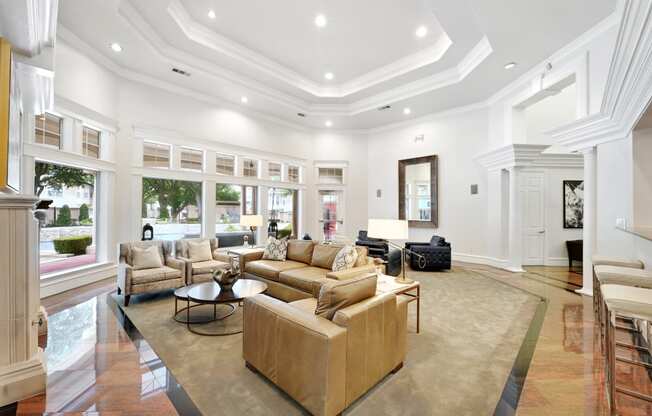 the living room has a coffered ceiling and large windows
