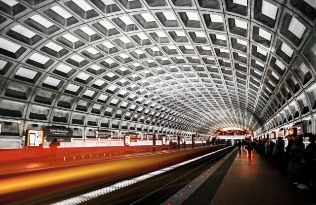The metro station near our apartments for rent in Washington DC, featuring a view of the arched ceiling and platform.
