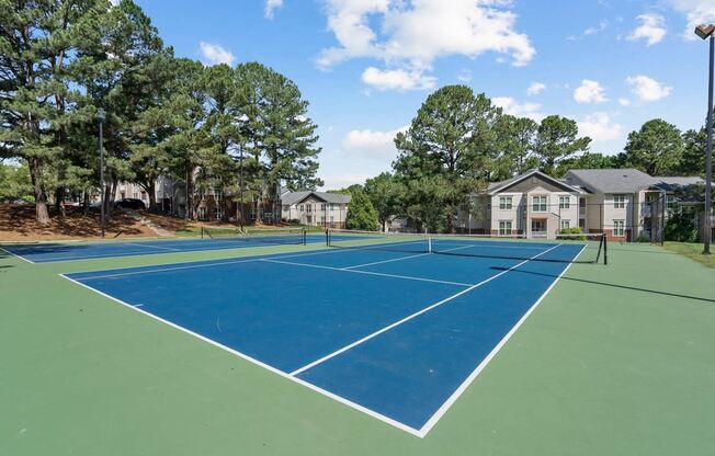 the tennis courts at the whispering winds apartments in pearland