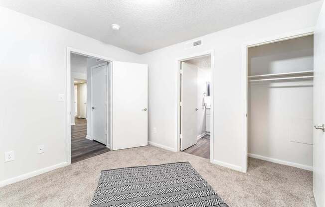 a renovated living room with white walls and a rug