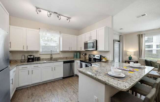 A kitchen with a table set for two.