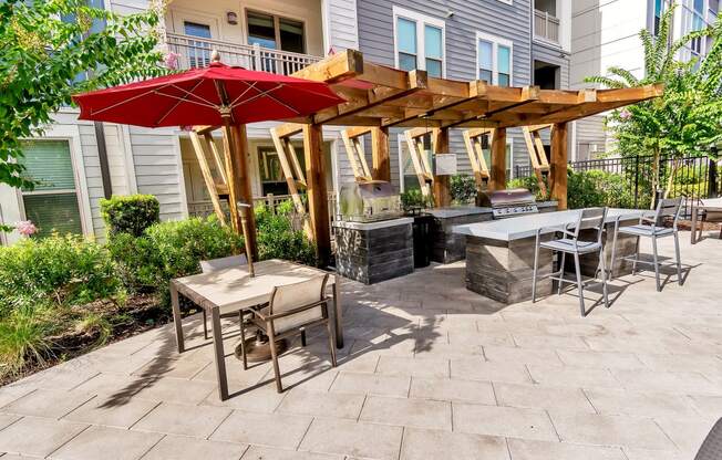 a patio with a fire pit and a pergola