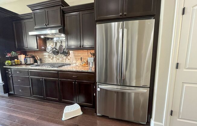 Stylish 5-Bedroom Home with Modern Kitchen, Stone Fireplace & Luxurious Primary Suite