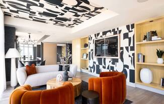 a living room with a white couch and a black and white wallpaper