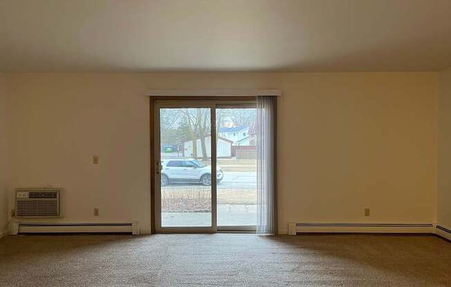 A room with a car parked outside the window.