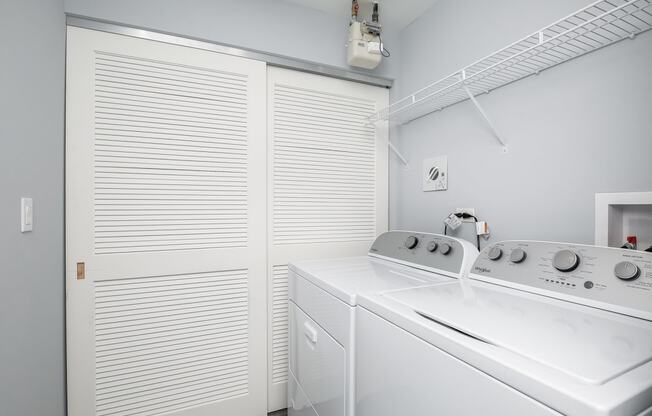 a white kitchen with a stove and a white closet