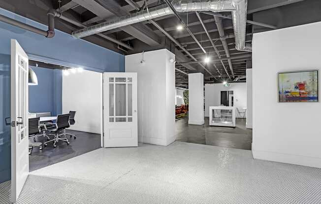 A room with a white floor and a white door.