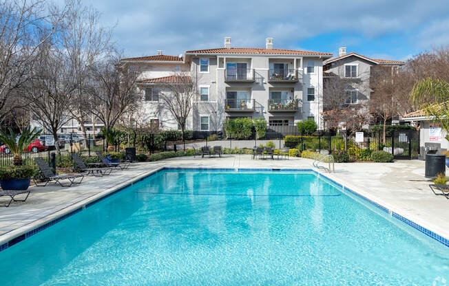 A swimming pool in front of a residential building at Cornerstone at Gale Ranch Apartments, San Ramon, CA
