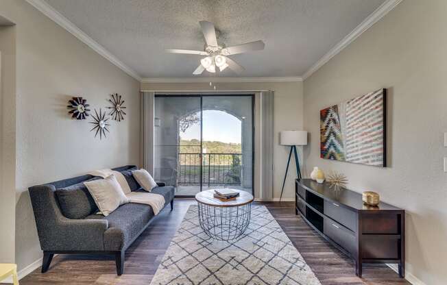 a living room with a couch and a ceiling fan