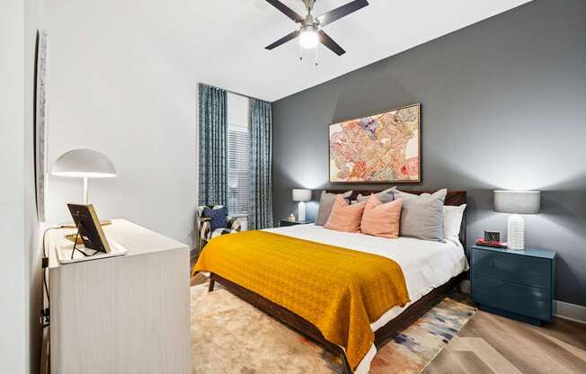 A bedroom with a bed, nightstand, and lamp.