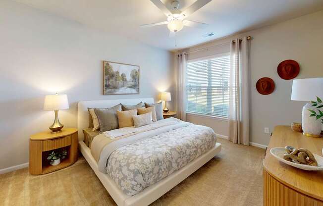 a large bedroom with plush carpet and a ceiling fan
