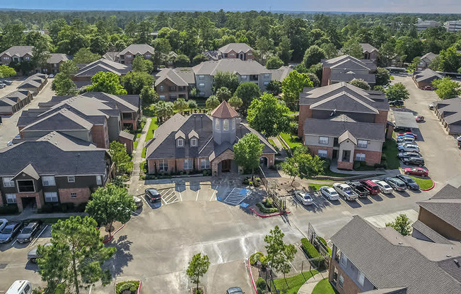 A bird's eye view of a residential area with houses and cars.