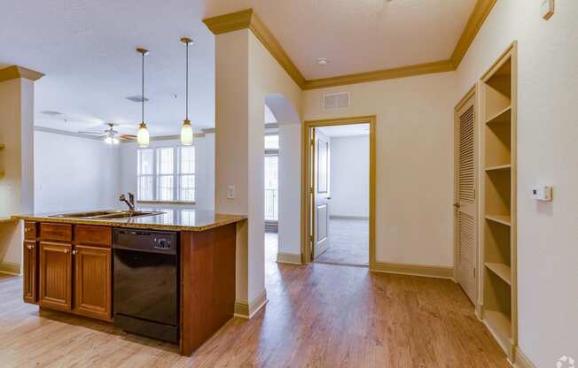 an open kitchen and dining room with a door to the living room