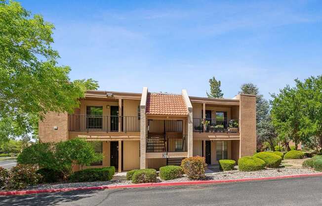 a building with a porch and a street in front of it at Acacia Gardens, Albuquerque, NM, 87111