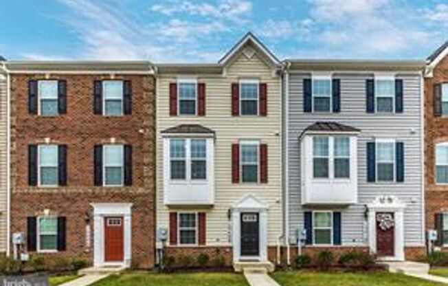 Three level townhouse with wood floor on main level, 2 car garage in the back