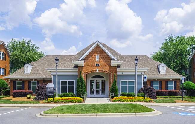 a house with a driveway and lawn in front of it