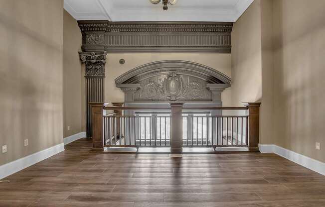 a living room with a fireplace and a wooden floor at The Knights @ 506 Delaware Apartments, Buffalo, 14202