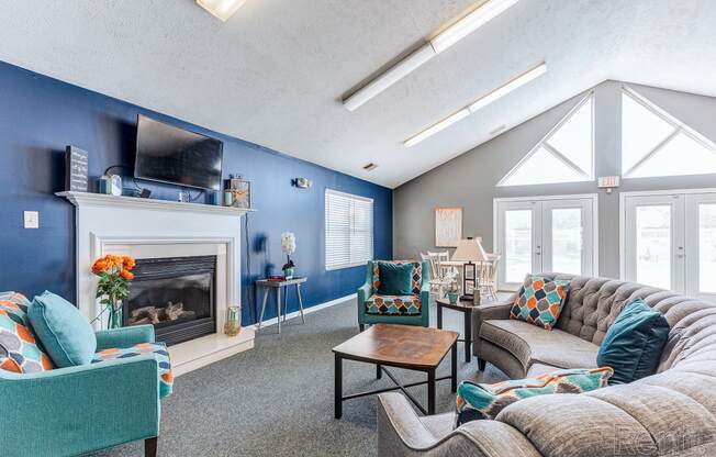 a living room with couches and chairs and a fireplace