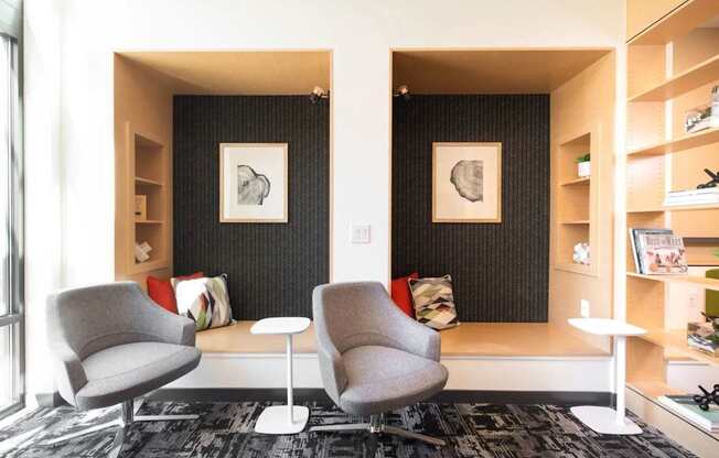A living room with two chairs and a table.