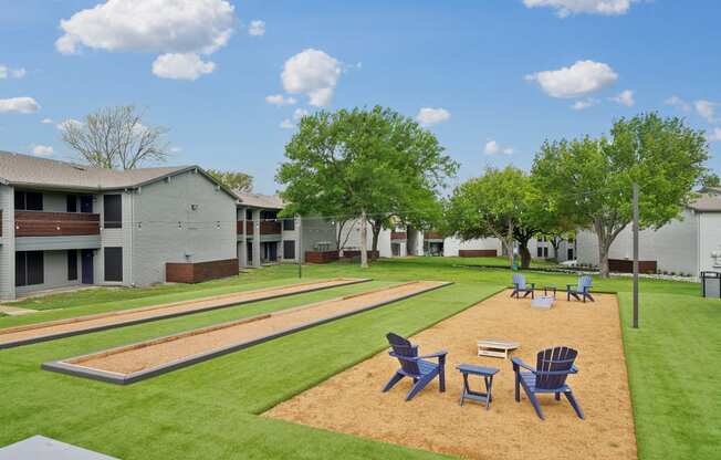 our apartments have a large yard with tables and chairs