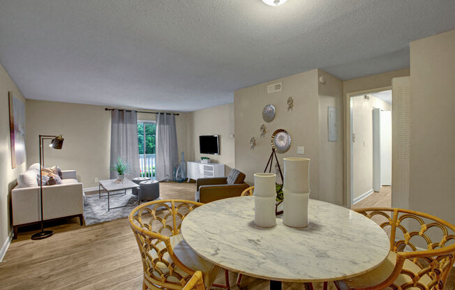 Living room, wood-like flooring, dining room table, four chairs