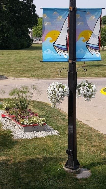 a pole with a painting of a sailboat on it