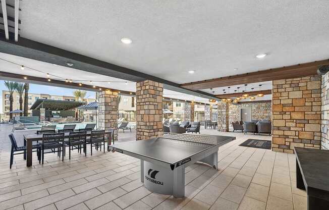 outdoor pong table with seating next to the pool