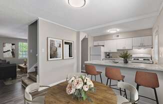 open concept kitchen with bar  Living Room with wood flooring at Midtown Oaks Townhomes in Mobile, AL