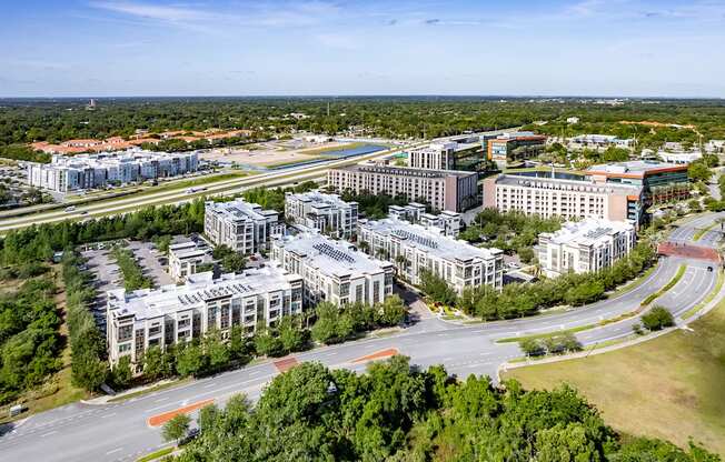 an aerial view of a city with buildings and a highway
