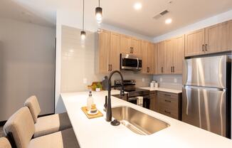 a kitchen with wooden cabinets and a white counter top