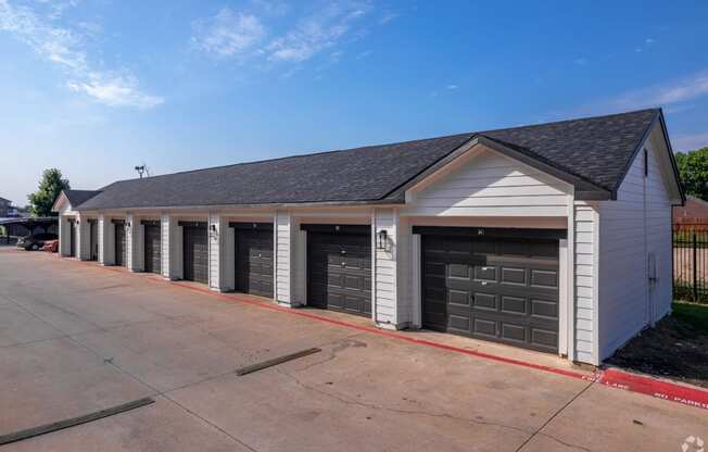 a garage with a row of doors on the side of a street