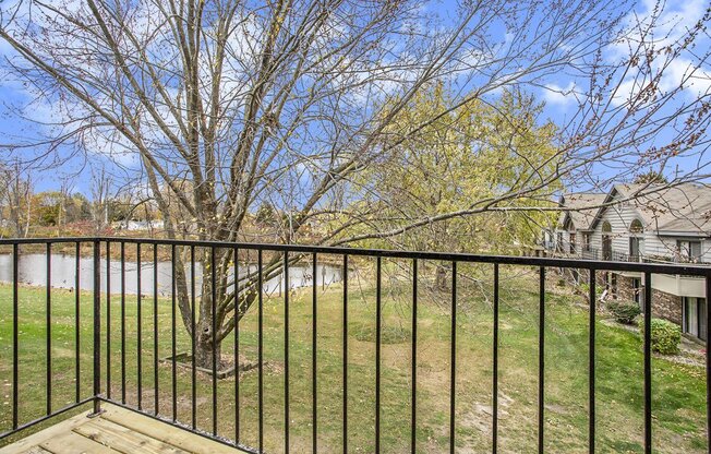 a balcony view with a tree and a pond at Hampton Lakes Apartments, Michigan, 49534